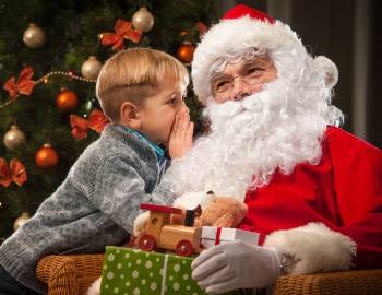 kid whispering to santa