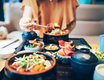 food in front of young woman at restaurant food in front of young woman at restaurant
